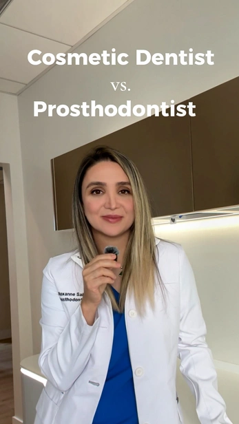 Dental professional in a white coat holding a dental tool, illustrating the difference between a cosmetic dentist and a prosthodontist.
