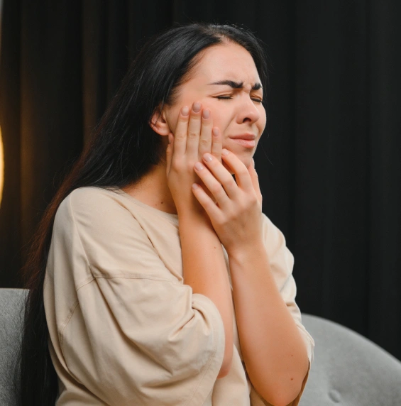 Patient experiencing severe tooth pain before receiving emergency dental treatment