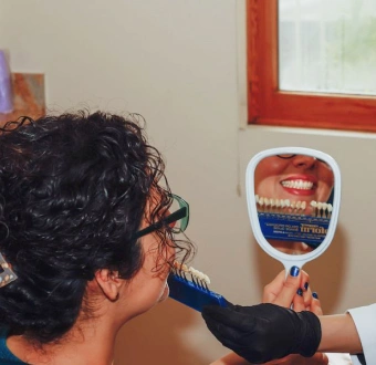 Dentist consulting with a patient about custom no-prep veneers for a natural smile enhancement