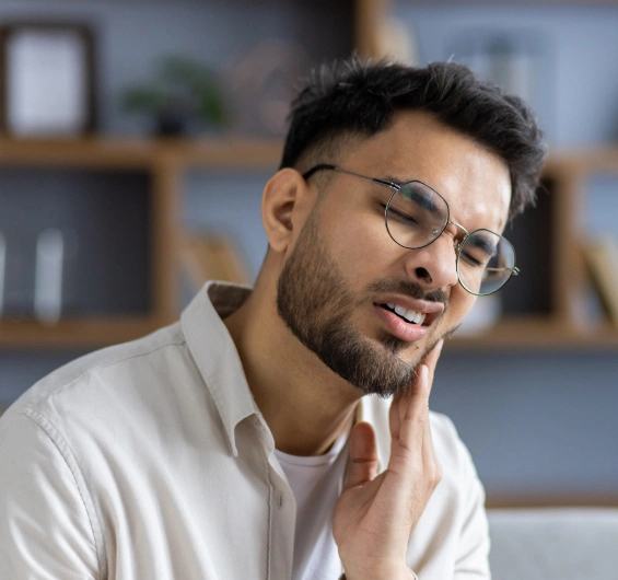 Patient experiencing jaw discomfort related to TMJ disorder