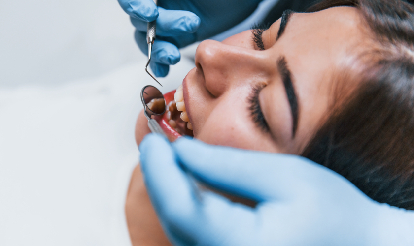 Dentist examining patient's teeth during dental treatment in Beverly Hills office.