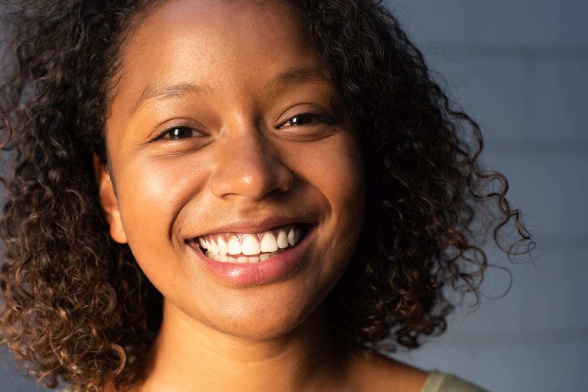 Woman smiling with bright white teeth at a Beverly Hills dental practice.